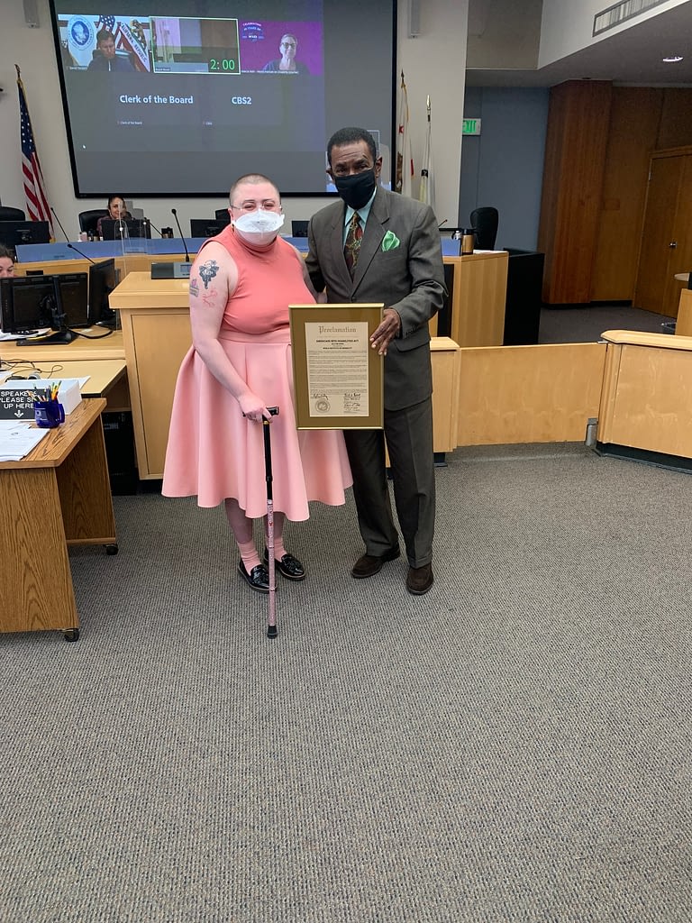 WID's Senior Marketing and Communications Specialist, Moya Shpuntoff and Alameda County Board of Supervisors President, Nate Miley pose together with framed proclamation plaque.