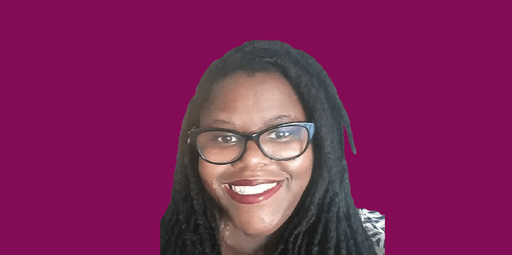 Lorrell Kilpatrick, a Black woman with locks, red lipstick and eyeglasses smiling