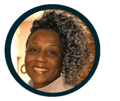 Author photo of Sabrinah White, a Black woman with curly black and gray hair, smiling.