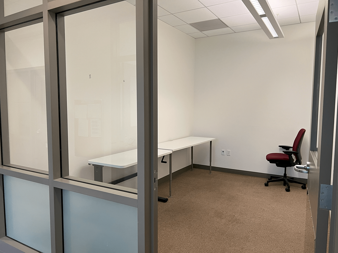 Smaller secured office with room for multiple desks. No windows to the exterior.