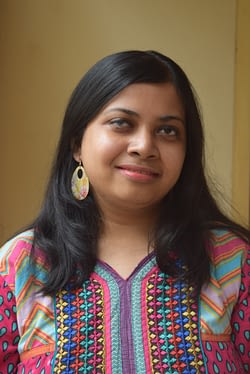 Author photo of Arundhati Nath, an Indian woman with shoulder length black hair. She is wearing a bright patterned shirt.
