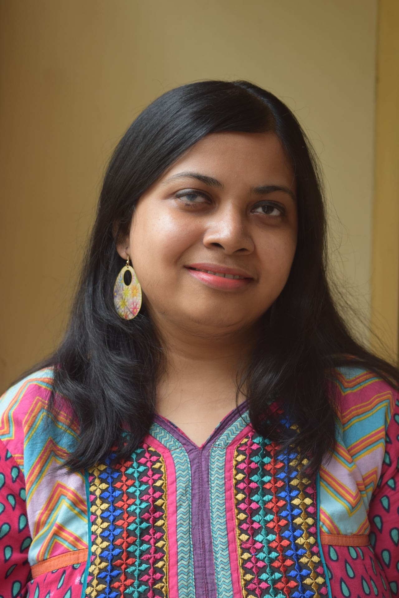 Author photo of Arundhati Nath, an Indian woman with shoulder length black hair. She is wearing a bright patterned top.