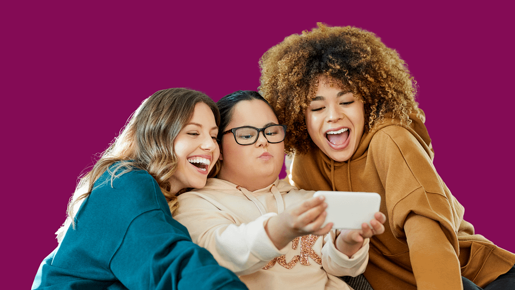 Three young women take a selfie on a smartphone.