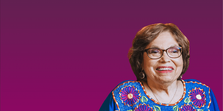 Judy Heumann smiling while wearing a floral blouse