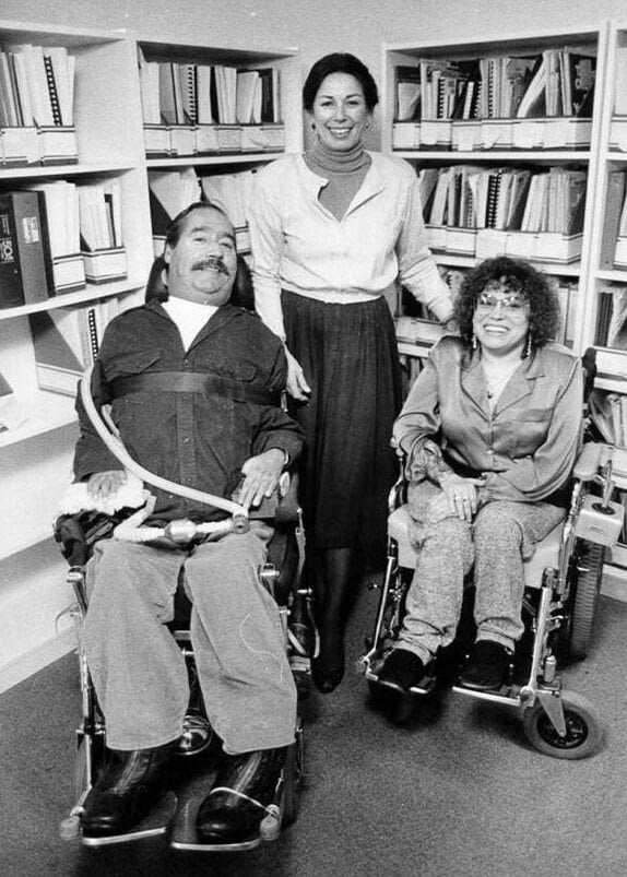 Black and white photo of the 3 founders of WID, Ed, Joan, and Judy. They are all smiling