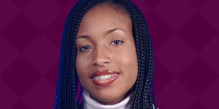 Kamilah Martin-Proctor, a Black woman with braids smiles.