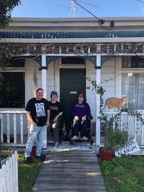 Stace Robertson, Etta Bollinger, and Erin Gough, at their Wellington flat with Wilson the cat.