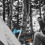 Woman sitting by tent