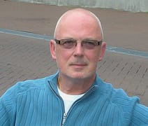 Photo of author Bob Goldstraw, a white adult man. He is wear slightly tinted glasses and a blue sweater.