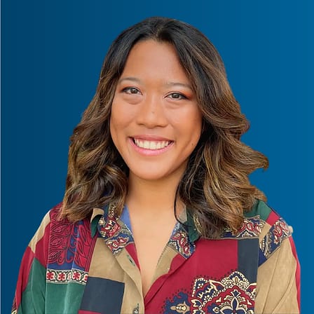 Alyssa Rapadas, an Asian woman with brown hair and a patterned colorful blouse.