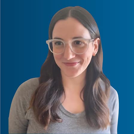 Headshot of Megan Lang, a white woman with long brown hair and glasses.