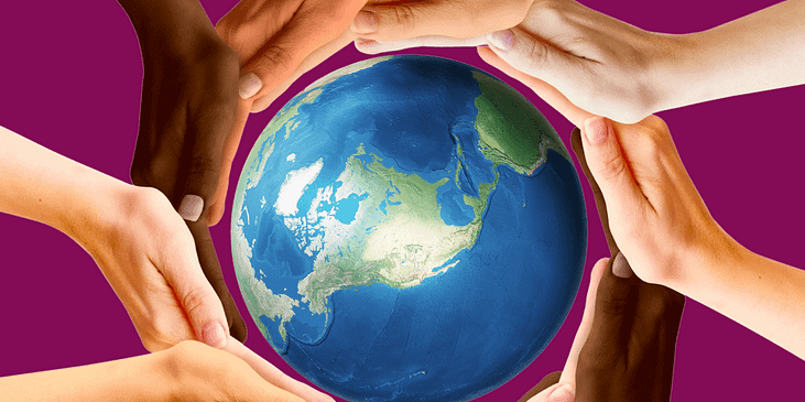 A group of hands with varying skin complexions surround a global depiction of the Earth.