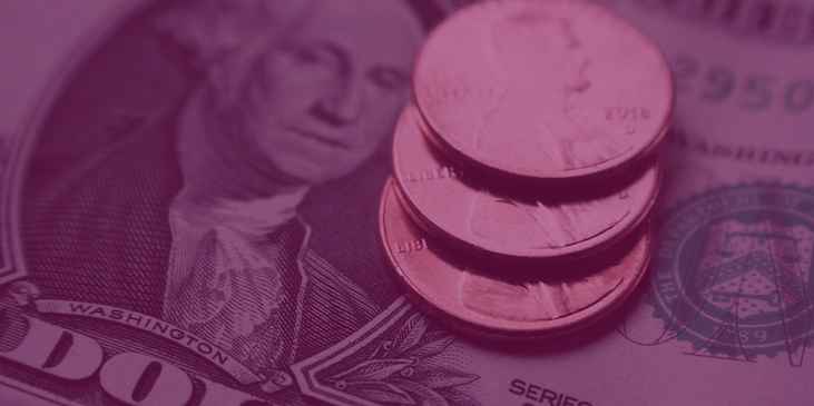 A dollar bill with coins stacked on top