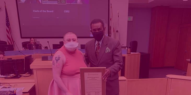 WID's Senior Marketing and Communications Specialist, Moya Shpuntoff and Alameda County Board of Supervisors President, Nate Miley pose together with framed proclamation plaque.