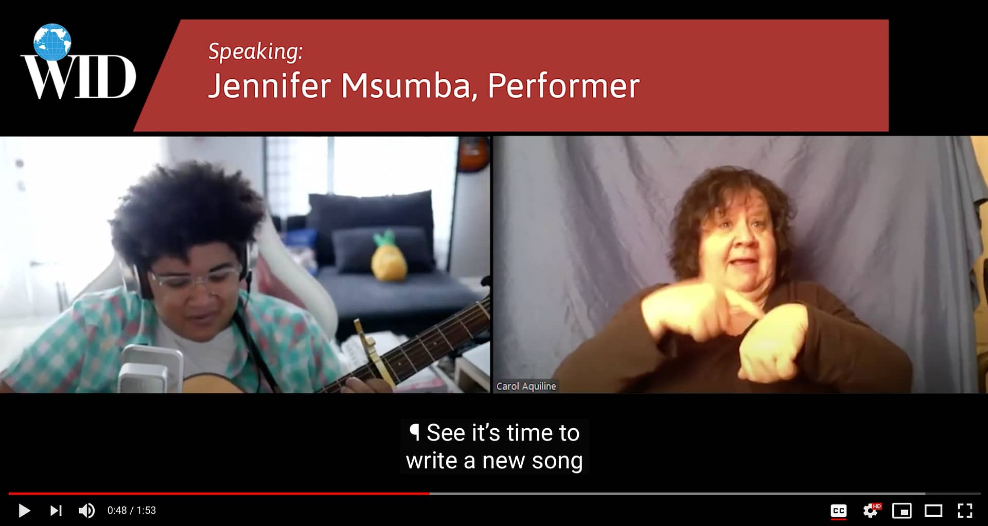 Screenshot of zoom meeting with performer Jennifer Msumba singing and playing guitar, while an International Sign interpreter, Carol Aquiline, signs alongside her. Caption reads: See it's time to write a new song.